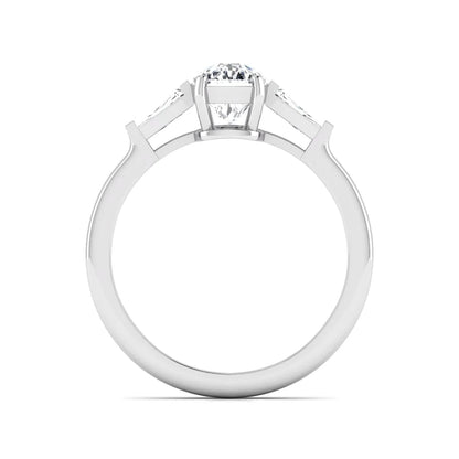 Cushion cut lab grown diamond three stone engagement ring with baguette side diamonds in a four prong setting and white gold tone band.