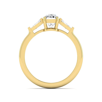 Cushion cut lab grown diamond three stone engagement ring with baguette side diamonds in a four prong setting and yellow gold tone band.