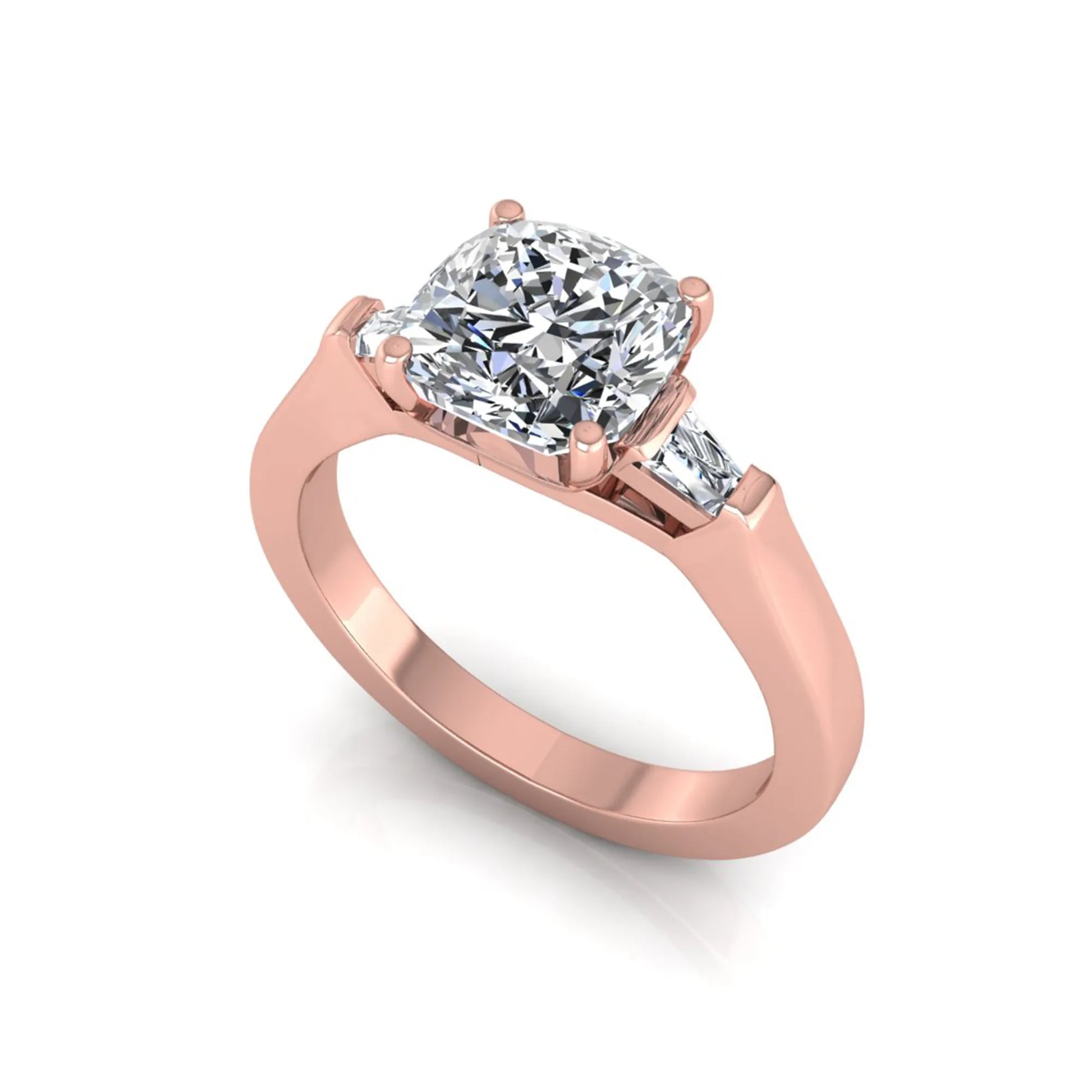 Cushion cut lab grown diamond three stone engagement ring featuring tapered baguette side diamonds in a four prong setting with yellow gold finish. in rose gold