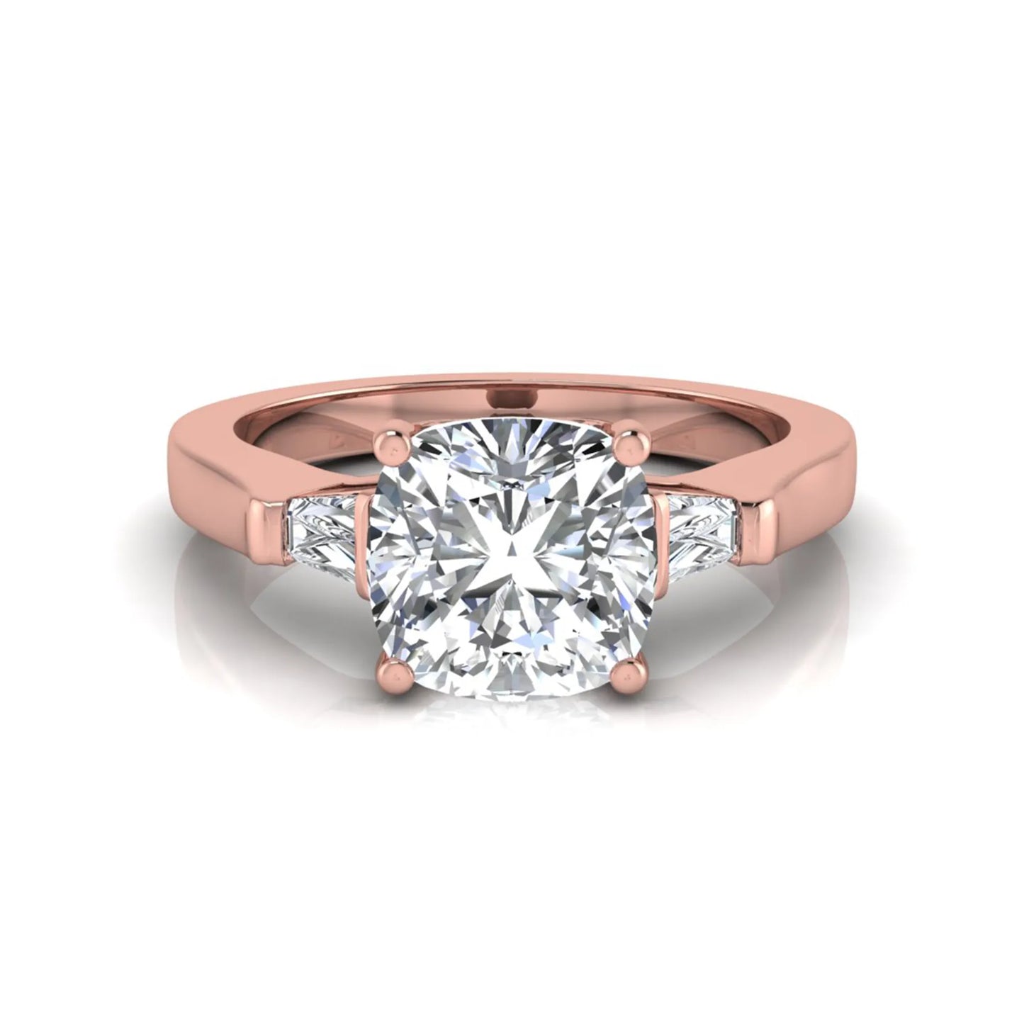 Cushion cut lab grown diamond three stone engagement ring featuring tapered baguette side diamonds in a four prong setting with yellow gold finish. in rose gold