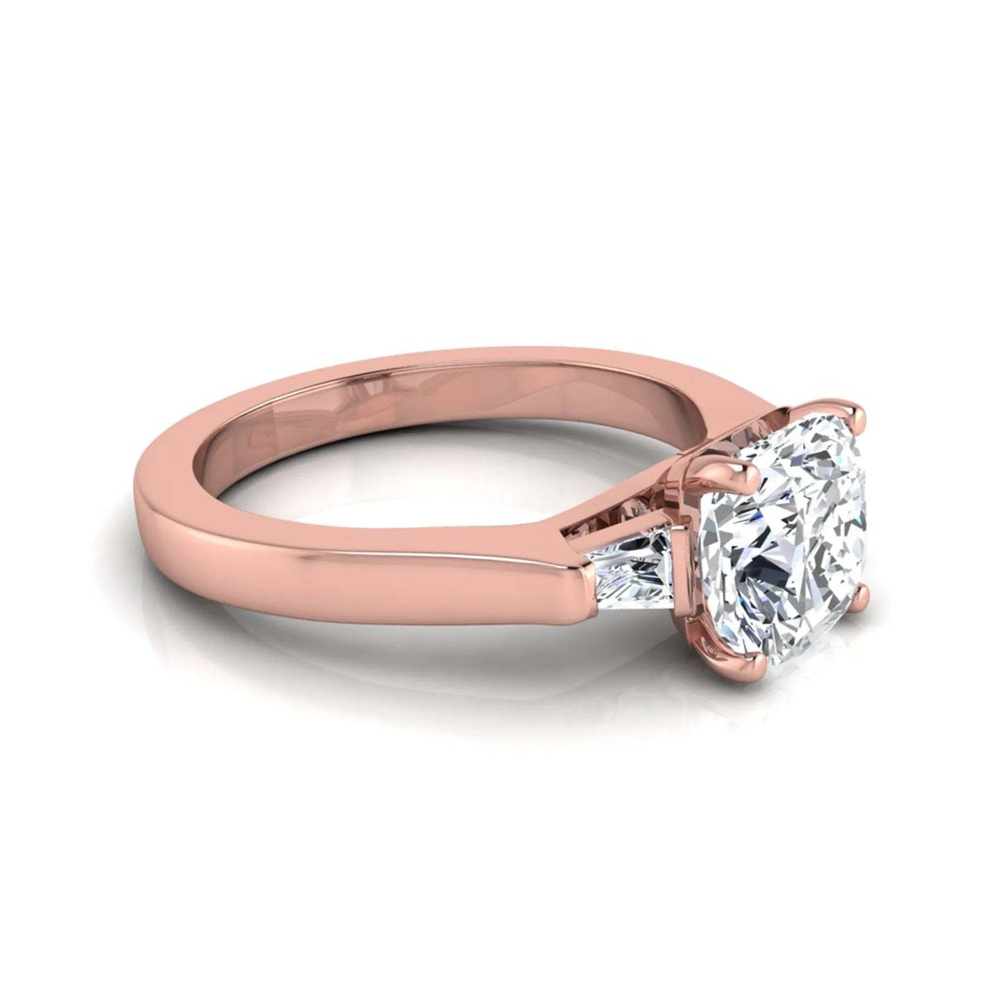 Cushion cut lab grown diamond three stone engagement ring featuring tapered baguette side diamonds in a four prong setting with yellow gold finish. in rose gold