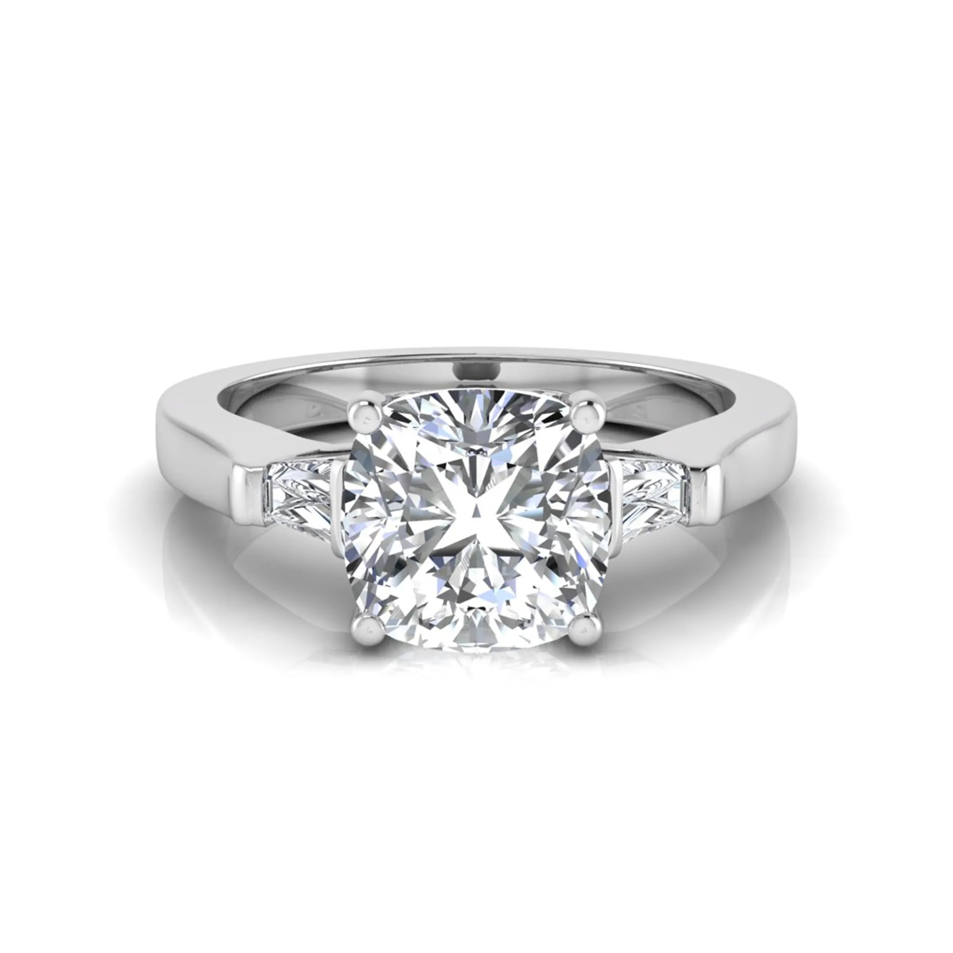 Cushion cut lab grown diamond three stone engagement ring featuring tapered baguette side diamonds in a four prong setting with yellow gold finish. in white gold