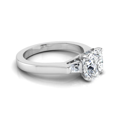 Cushion cut lab grown diamond three stone engagement ring featuring tapered baguette side diamonds in a four prong setting with yellow gold finish. in white gold