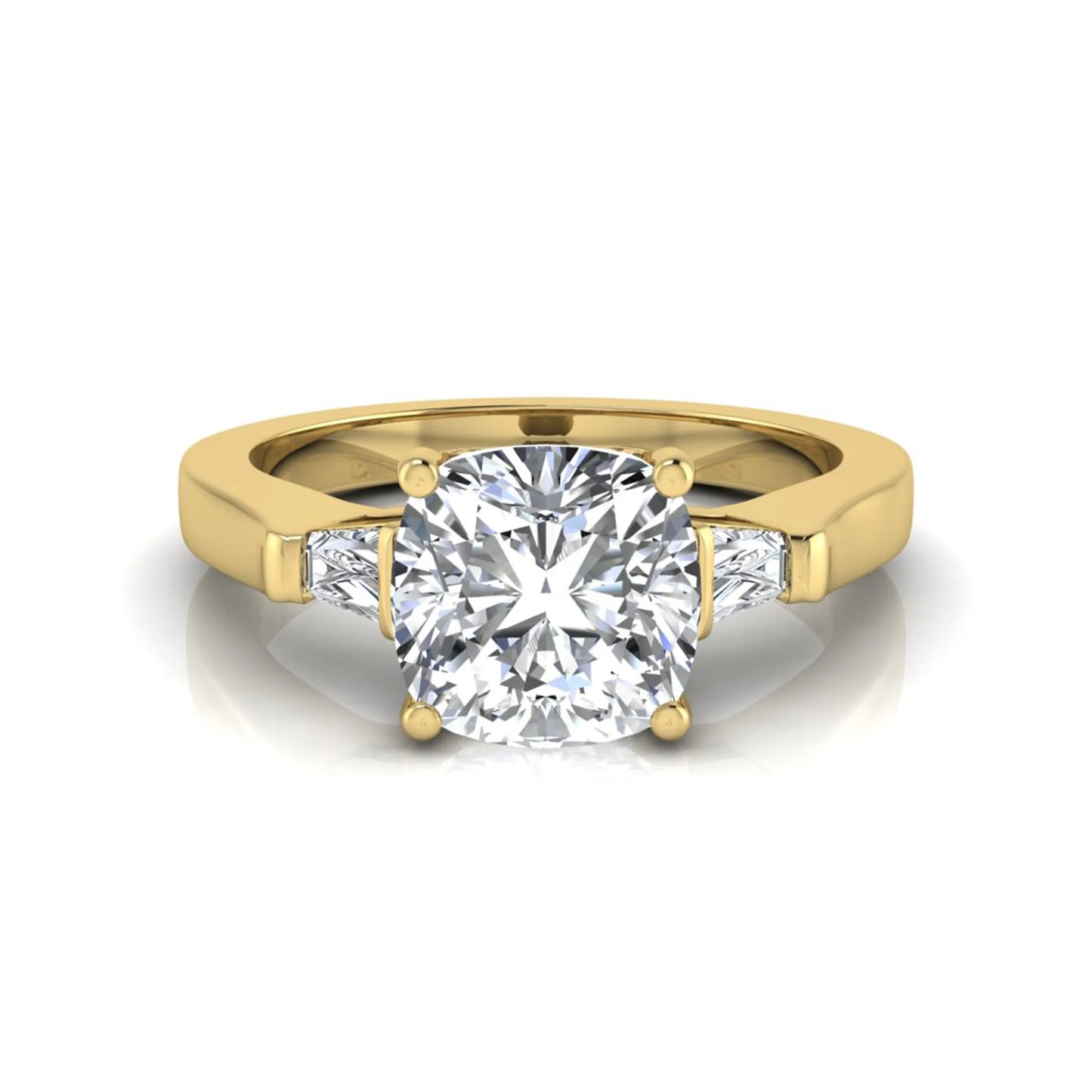 Cushion cut lab grown diamond three stone engagement ring featuring tapered baguette side diamonds in a four prong setting with yellow gold finish. in yellow gold