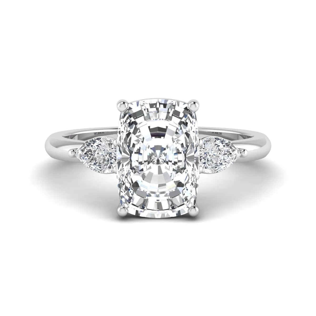 Elongated cushion cut lab grown diamond three stone engagement ring featuring pear cut side diamonds in a four-prong setting with a polished white gold tone band.
