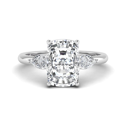 Elongated cushion cut lab grown diamond three stone engagement ring featuring pear cut side diamonds in a four-prong setting with a polished white gold tone band.