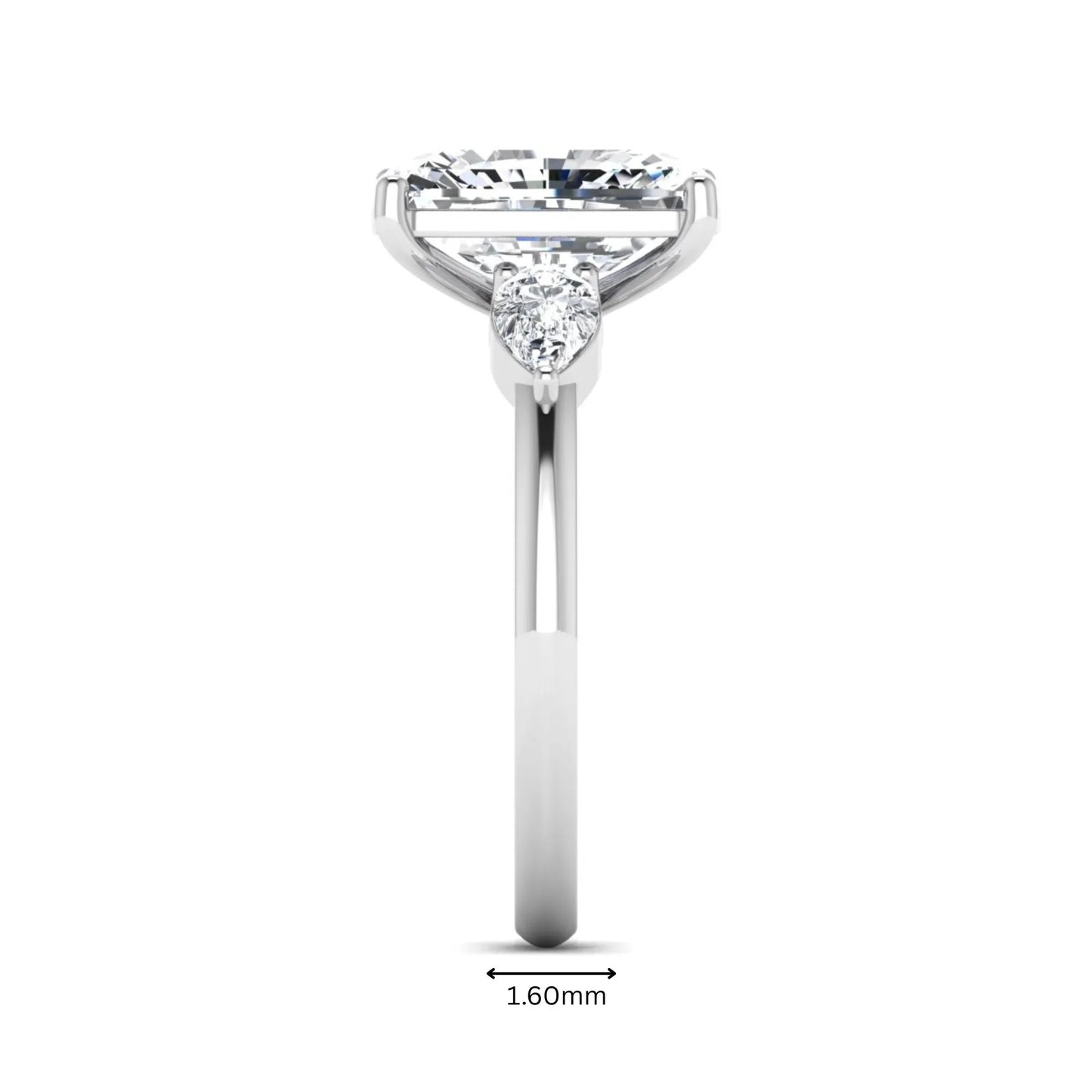 Elongated cushion cut lab grown diamond three stone engagement ring featuring pear cut side diamonds in a four-prong setting with a polished white gold tone band.