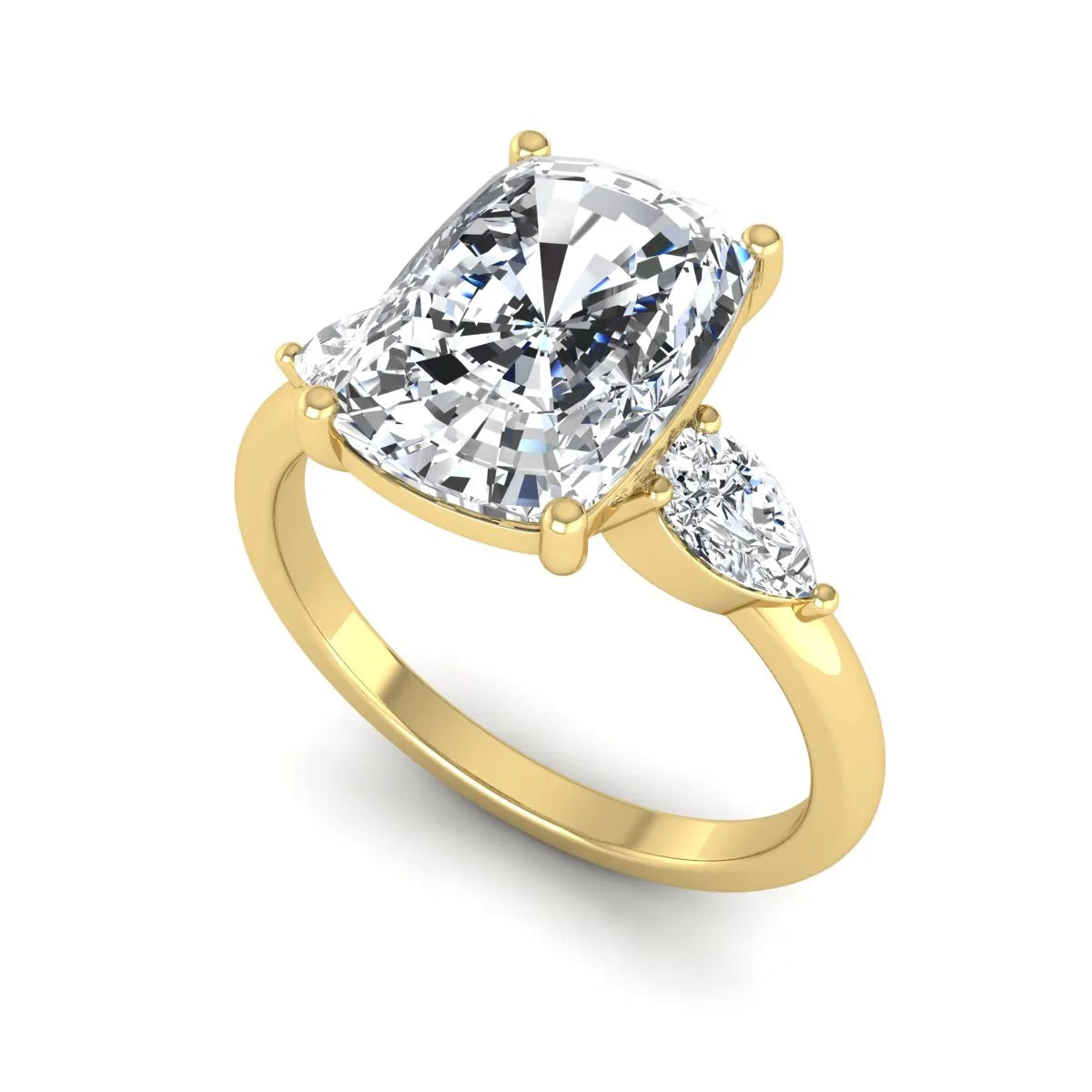 Elongated cushion cut lab grown diamond three stone engagement ring featuring pear cut side diamonds in a four-prong setting with a polished yellow gold tone band.