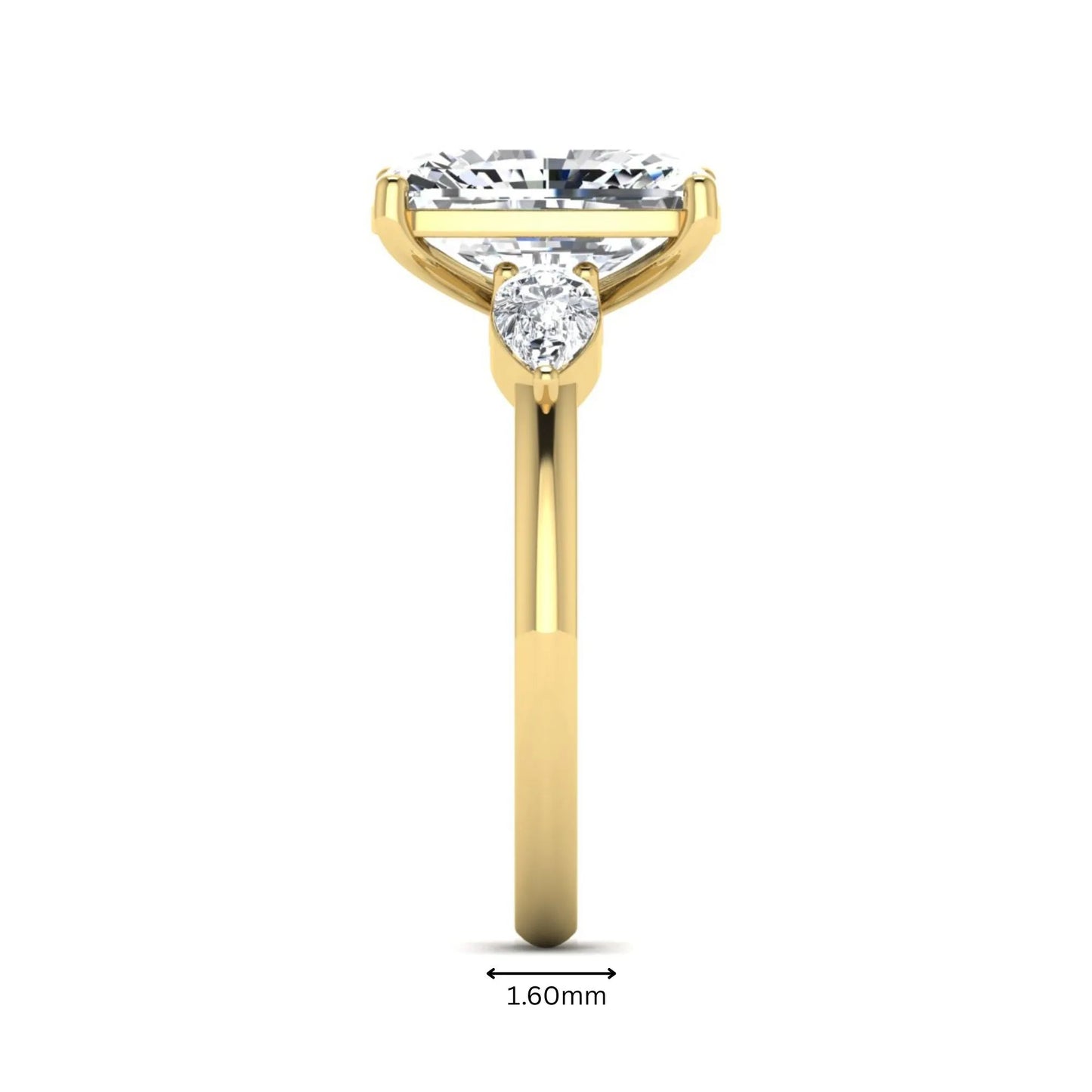 Elongated cushion cut lab grown diamond three stone engagement ring featuring pear cut side diamonds in a four-prong setting with a polished yellow gold tone band.