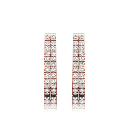 Double row round cut lab grown diamond huggie hoop earrings featuring shared prong set diamonds, hinged snap closure, and polished rose gold finish.