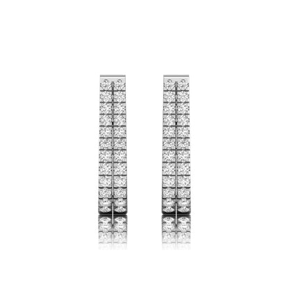 Double row round cut lab grown diamond huggie hoop earrings featuring shared prong set diamonds, hinged snap closure, and polished white gold finish.