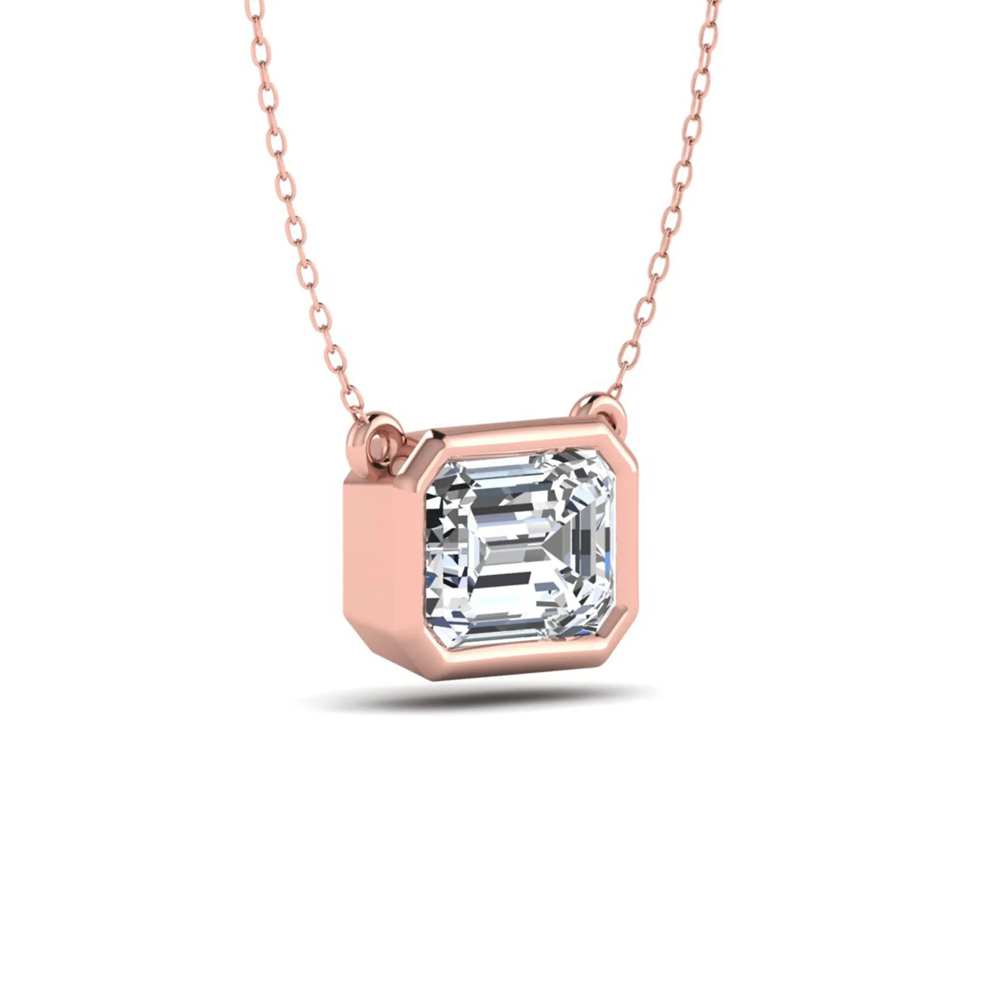Emerald cut lab grown diamond solitaire pendant necklace with a modern bezel setting in a polished rose gold metal finish.