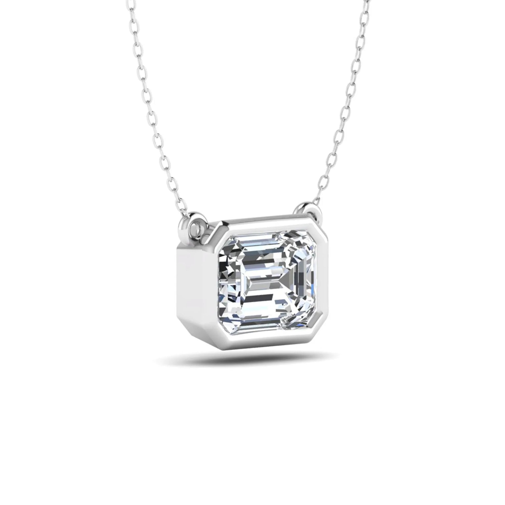 Emerald cut lab grown diamond solitaire pendant necklace with a modern bezel setting in a polished white gold metal finish.