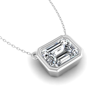 Emerald cut lab grown diamond solitaire pendant necklace with a modern bezel setting in a polished white gold metal finish.