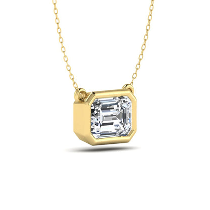 Emerald cut lab grown diamond solitaire pendant necklace with a modern bezel setting in a polished yellow gold metal finish.