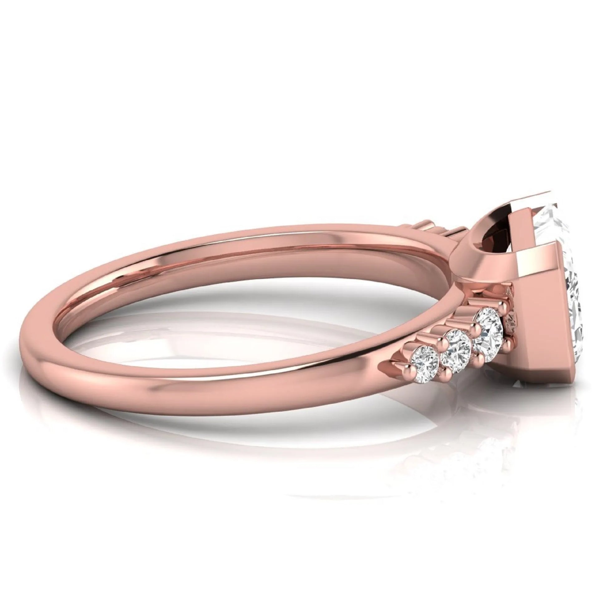 Emerald cut lab grown diamond engagement ring featuring a horizontal east-west bezel-set center diamond with graduated round side diamonds in a rose gold tone.
