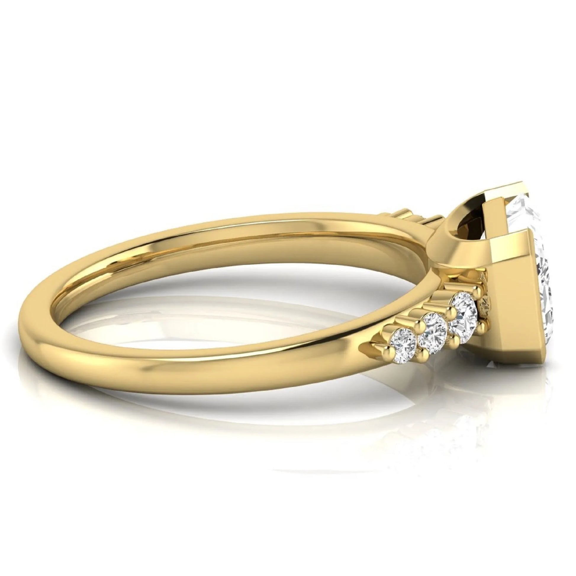 Emerald cut lab grown diamond engagement ring featuring a horizontal east-west bezel-set center diamond with graduated round side diamonds in a yellow gold tone.