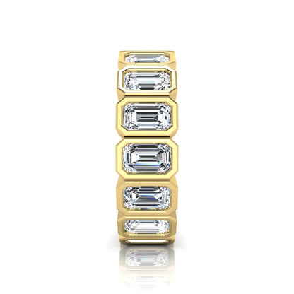 Emerald cut lab grown diamond full eternity ring featuring octagonal bezel-set diamonds in polished yellow gold.
