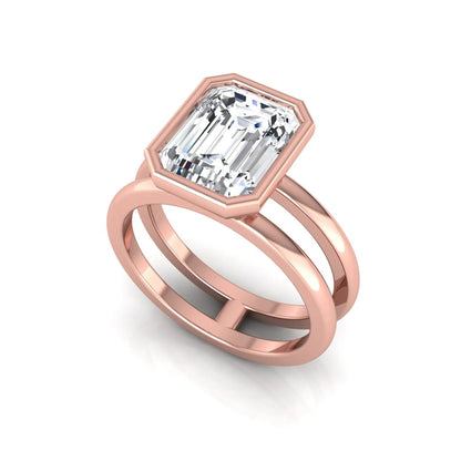 Rose-gold ring with emerald-cut diamond on a white background
