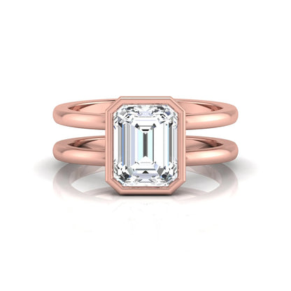 Rose-gold ring with emerald-cut diamond on a white background