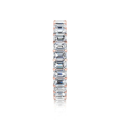 Emerald cut lab grown diamond eternity band featuring a continuous row of shared prong set diamonds in a timeless luxury design in rose gold