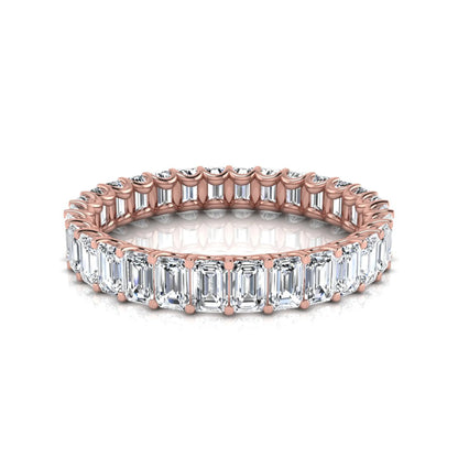 Emerald cut lab grown diamond eternity band featuring a continuous row of shared prong set diamonds in a timeless luxury design in rose gold