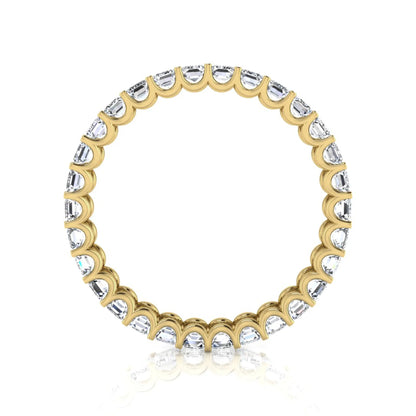 Emerald cut lab grown diamond eternity band featuring a continuous row of shared prong set diamonds in a timeless luxury design in yellow gold
