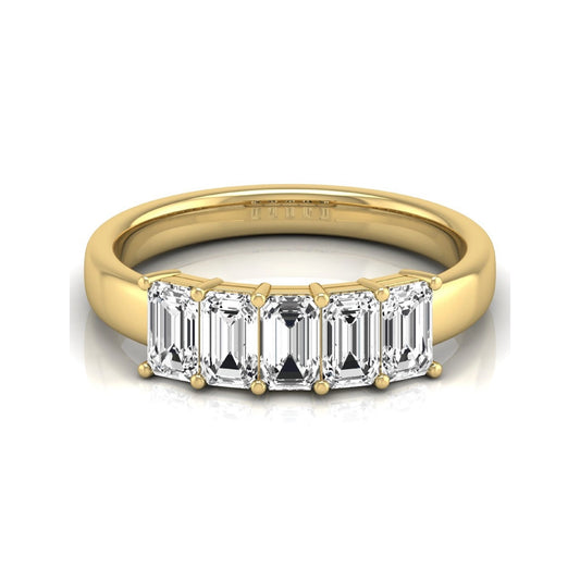 Emerald cut five stone lab grown diamond anniversary ring featuring five emerald cut diamonds in a shared prong setting with a yellow gold tone band.
