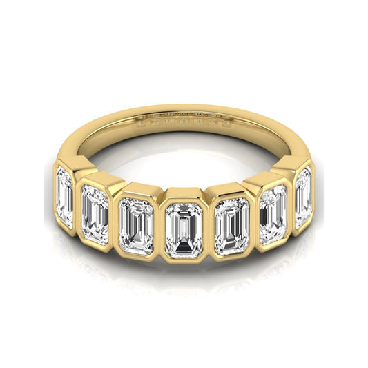 Emerald cut lab grown diamond bezel seven stone band featuring 2.03 carats of bezel set emerald diamonds in yellow gold.