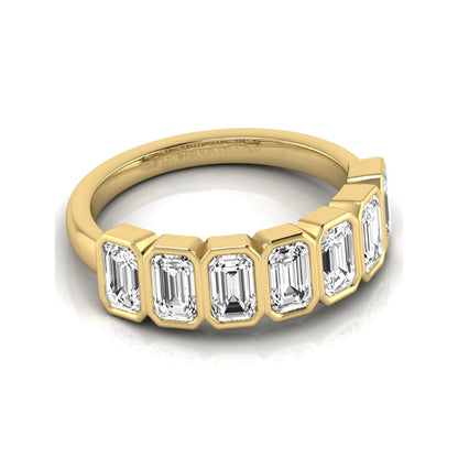 Emerald cut lab grown diamond bezel seven stone band featuring 2.03 carats of bezel set emerald diamonds in yellow gold.