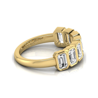 Emerald cut lab grown diamond bezel seven stone band featuring 2.03 carats of bezel set emerald diamonds in yellow gold.