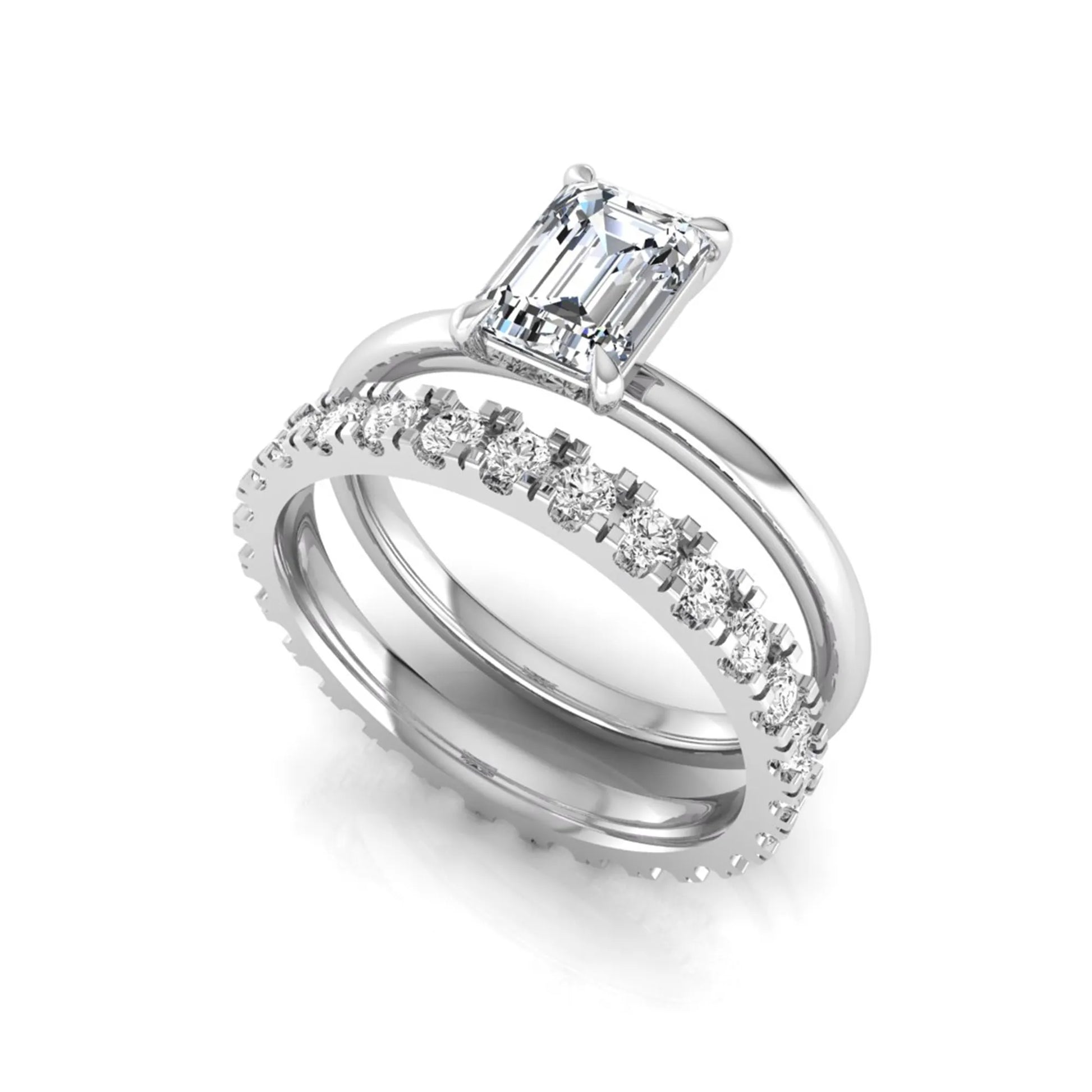 Emerald cut lab grown diamond bridal ring set featuring a 1.06 carat IGI certified center diamond with a matching round diamond wedding band in white gold.