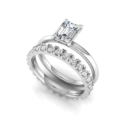 Emerald cut lab grown diamond bridal ring set featuring a 1.06 carat IGI certified center diamond with a matching round diamond wedding band in white gold.