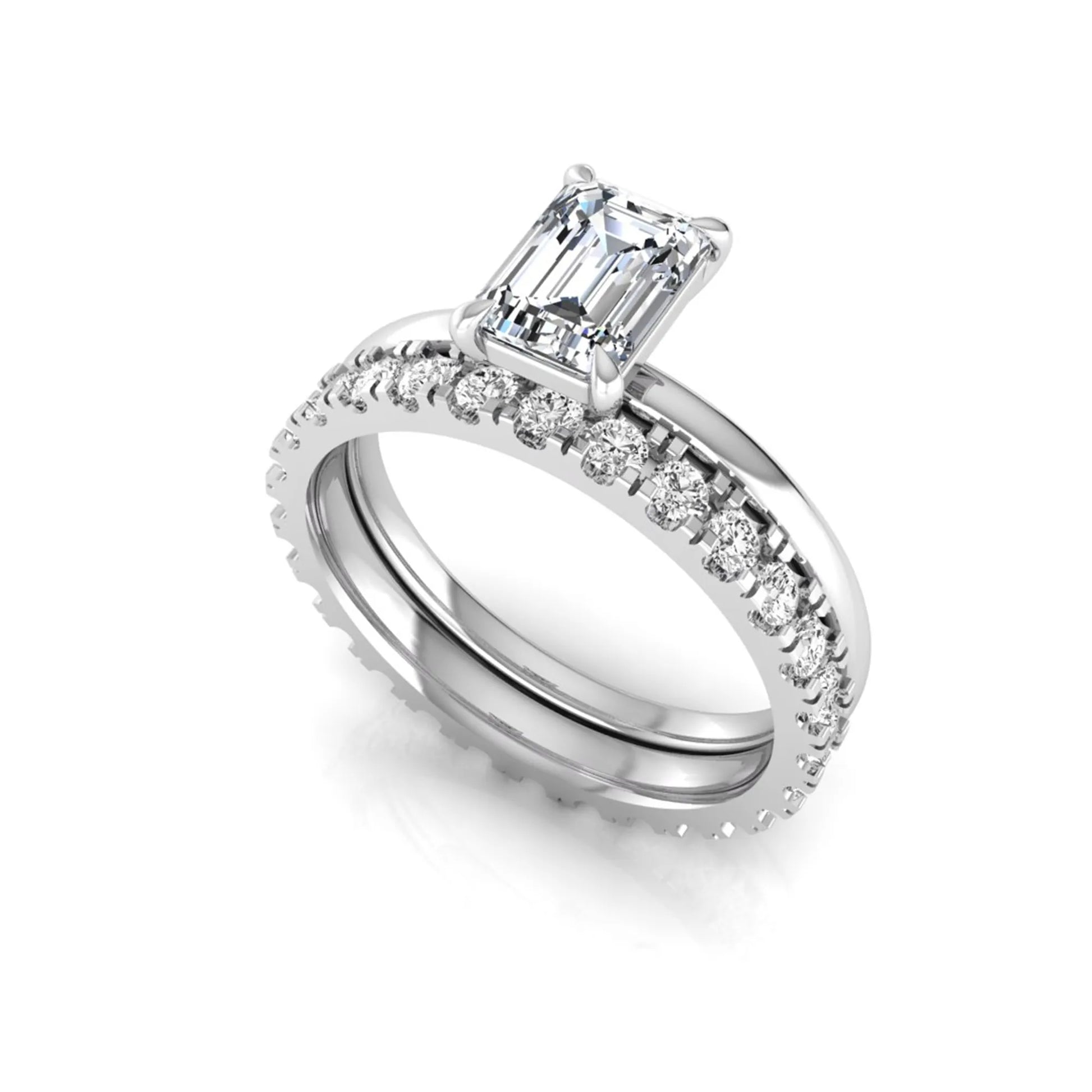 Emerald cut lab grown diamond bridal ring set featuring a 1.06 carat IGI certified center diamond with a matching round diamond wedding band in white gold.