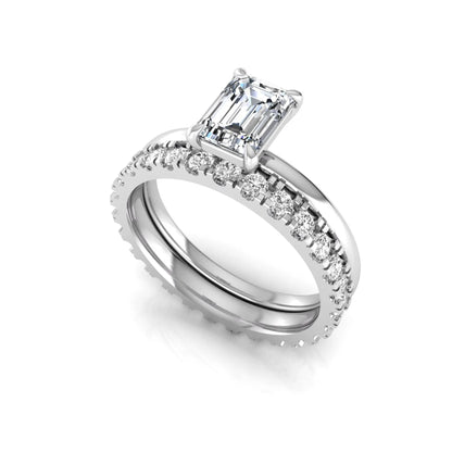 Emerald cut lab grown diamond bridal ring set featuring a 1.06 carat IGI certified center diamond with a matching round diamond wedding band in white gold.