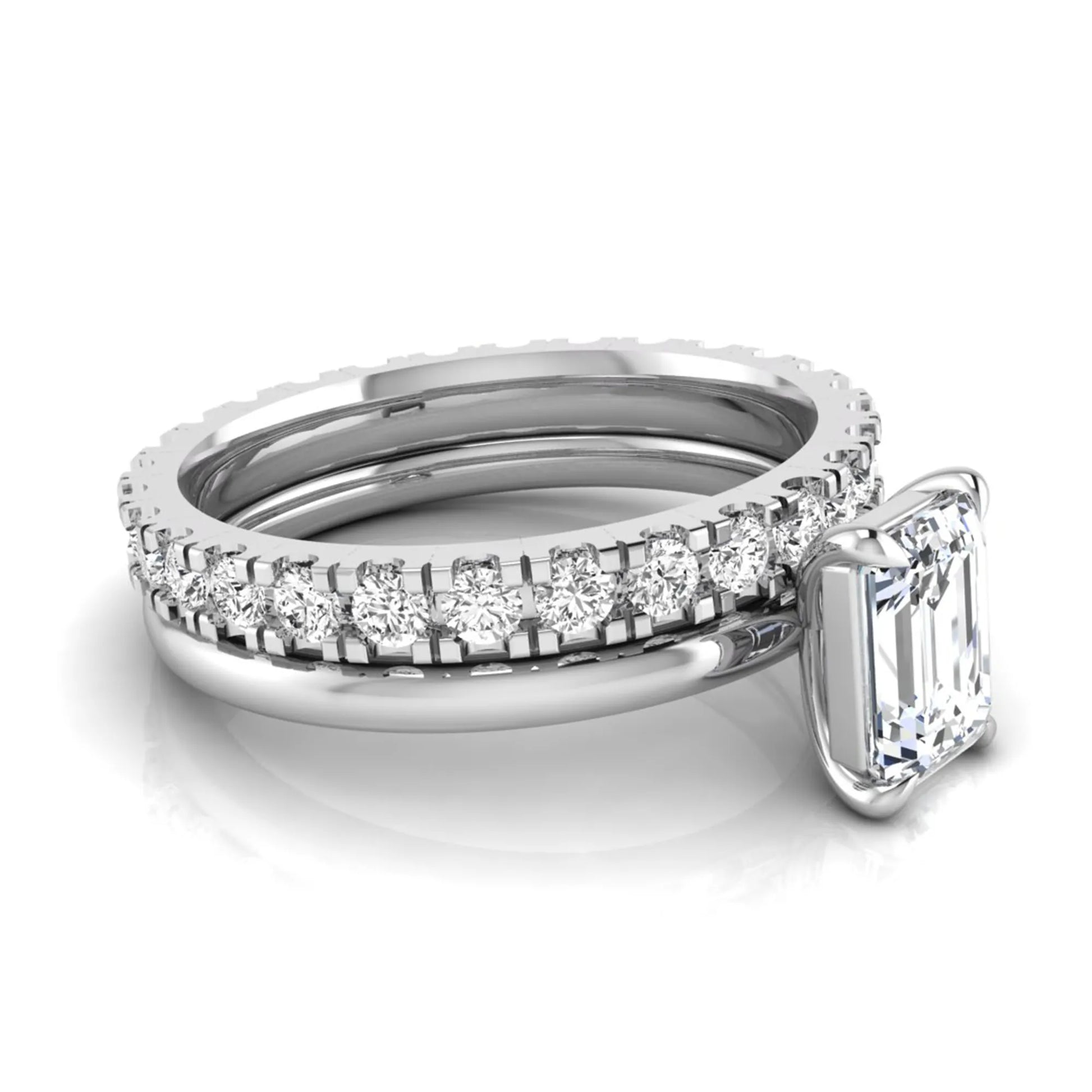 Emerald cut lab grown diamond bridal ring set featuring a 1.06 carat IGI certified center diamond with a matching round diamond wedding band in white gold.