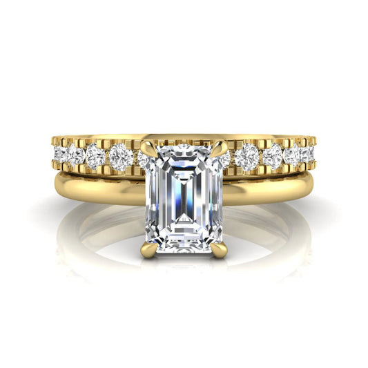 Emerald cut lab grown diamond bridal ring set featuring a 1.06 carat IGI certified center diamond with a matching round diamond wedding band in yellow gold.