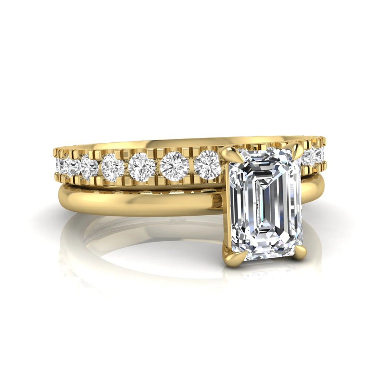 Emerald cut lab grown diamond bridal ring set featuring a 1.06 carat IGI certified center diamond with a matching round diamond wedding band in yellow gold.