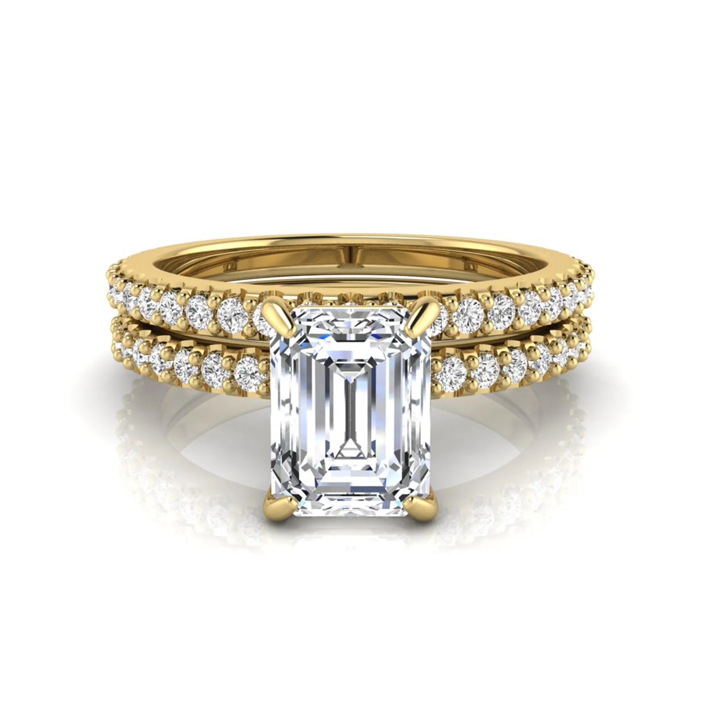 Emerald cut lab grown diamond bridal ring set featuring a 1.74 carat IGI certified emerald cut center diamond with a matching pavé diamond wedding band in yellow gold