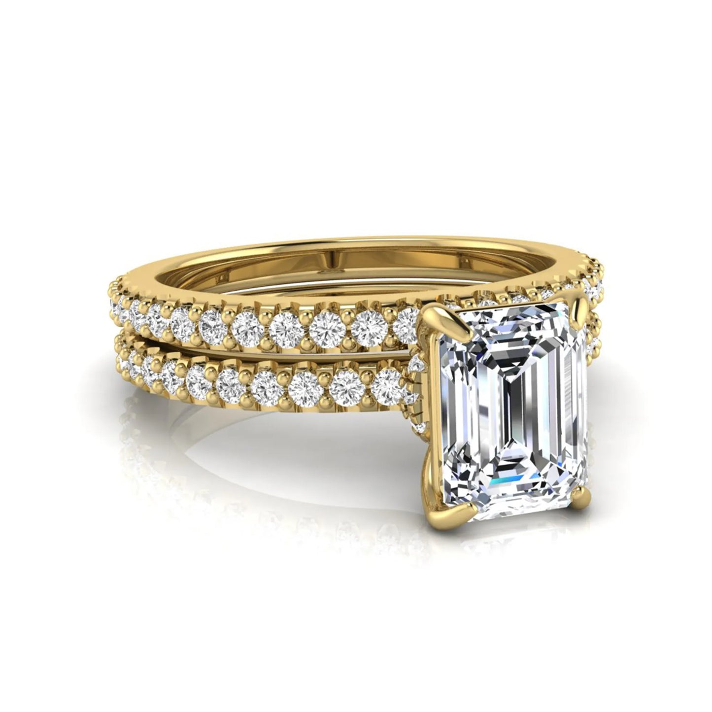Emerald cut lab grown diamond bridal ring set featuring a 1.74 carat IGI certified emerald cut center diamond with a matching pavé diamond wedding band in yellow gold