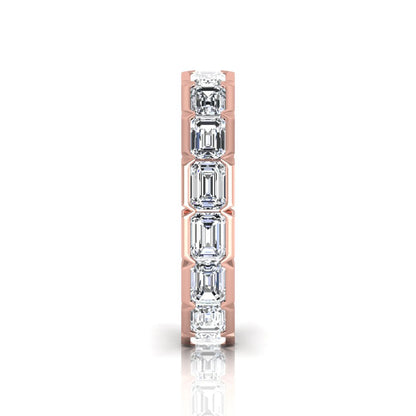 Emerald cut lab grown diamond eternity ring featuring a continuous row of step-cut diamonds in a modern full bezel setting in rose gold