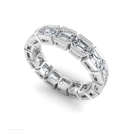 Emerald cut lab grown diamond eternity ring featuring a continuous row of step-cut diamonds in a modern full bezel setting in white gold