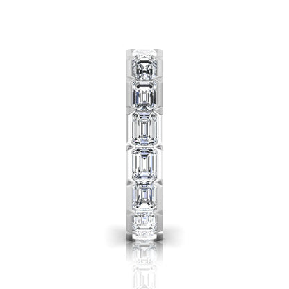 Emerald cut lab grown diamond eternity ring featuring a continuous row of step-cut diamonds in a modern full bezel setting in white gold
