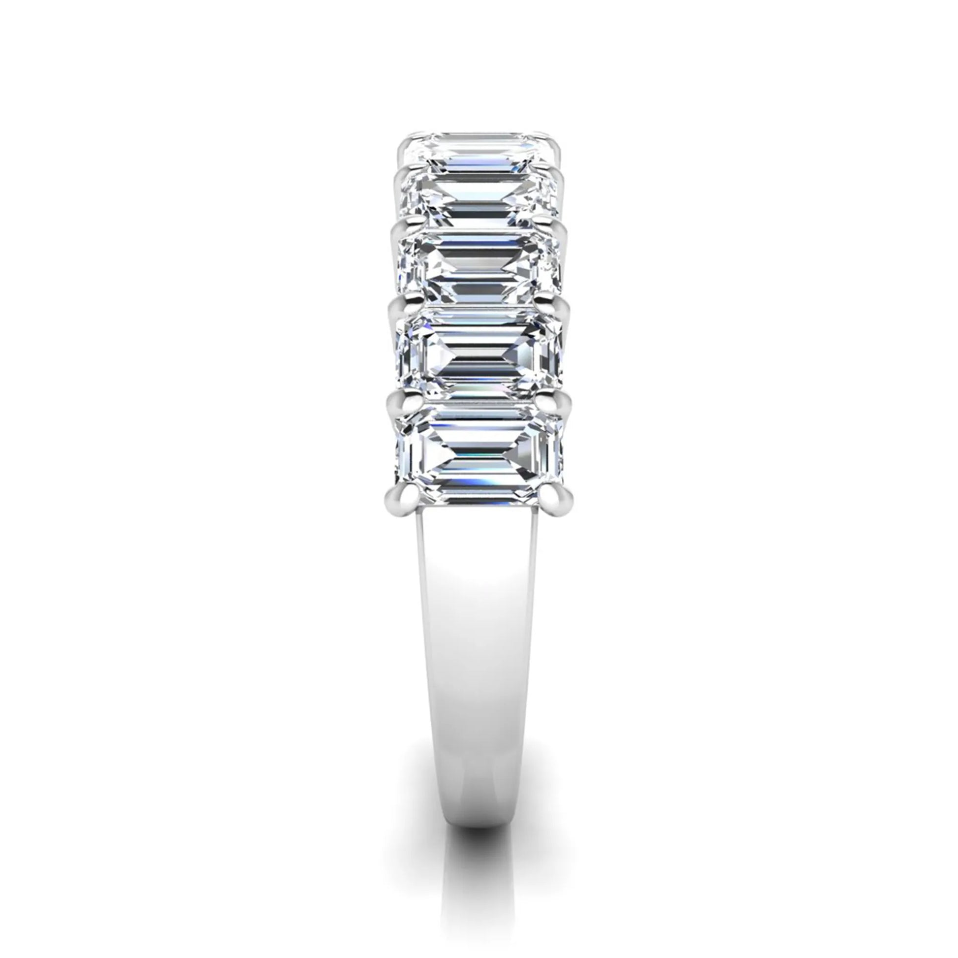Emerald cut lab grown diamond half eternity band featuring shared prong set diamonds in a white gold tone finish.