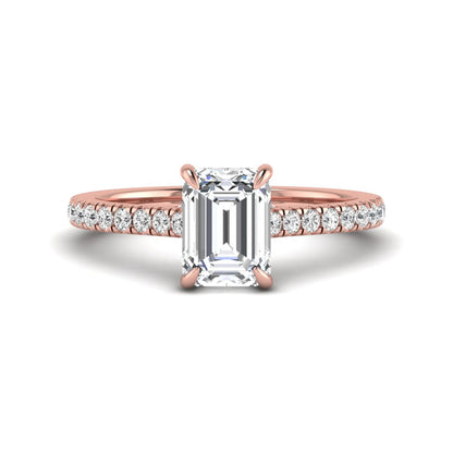 IGI certified emerald cut lab grown diamond hidden halo engagement ring with pavé round diamond band in rose gold.