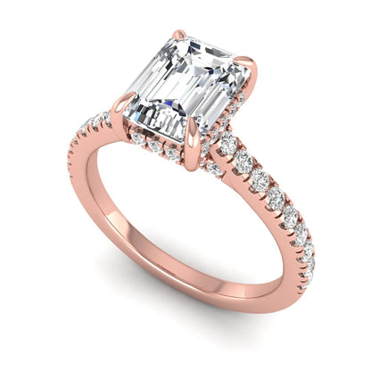IGI certified emerald cut lab grown diamond hidden halo engagement ring with pavé round diamond band in rose gold.