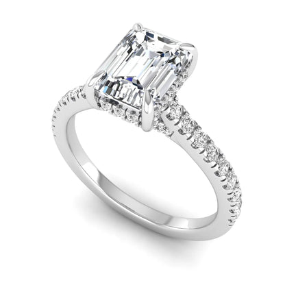 IGI certified emerald cut lab grown diamond hidden halo engagement ring with pavé round diamond band in white gold.