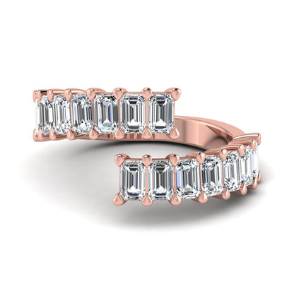 Emerald cut lab grown diamond open cuff bypass ring with prong setting in rose gold tone.