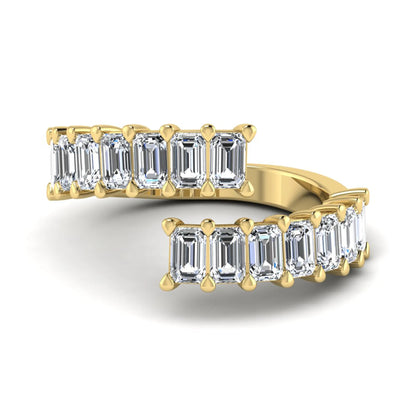 Emerald cut lab grown diamond open cuff bypass ring with prong setting in yellow gold tone.