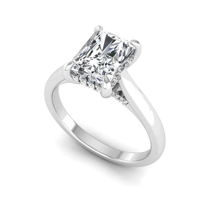 Emerald cut lab grown diamond solitaire engagement ring featuring a 1.74 carat IGI certified center diamond with hidden pavé accents in white gold.
